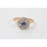 Edwardian sapphire and diamond cluster ring with a central blue sapphire cabochon surrounded by