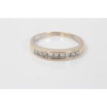 Gold (stamped 18k) diamond half eternity ring, with nine princess cut diamonds in channel setting,