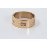 Gold (9ct) thick banded ring with large hallmark decoration, size O.