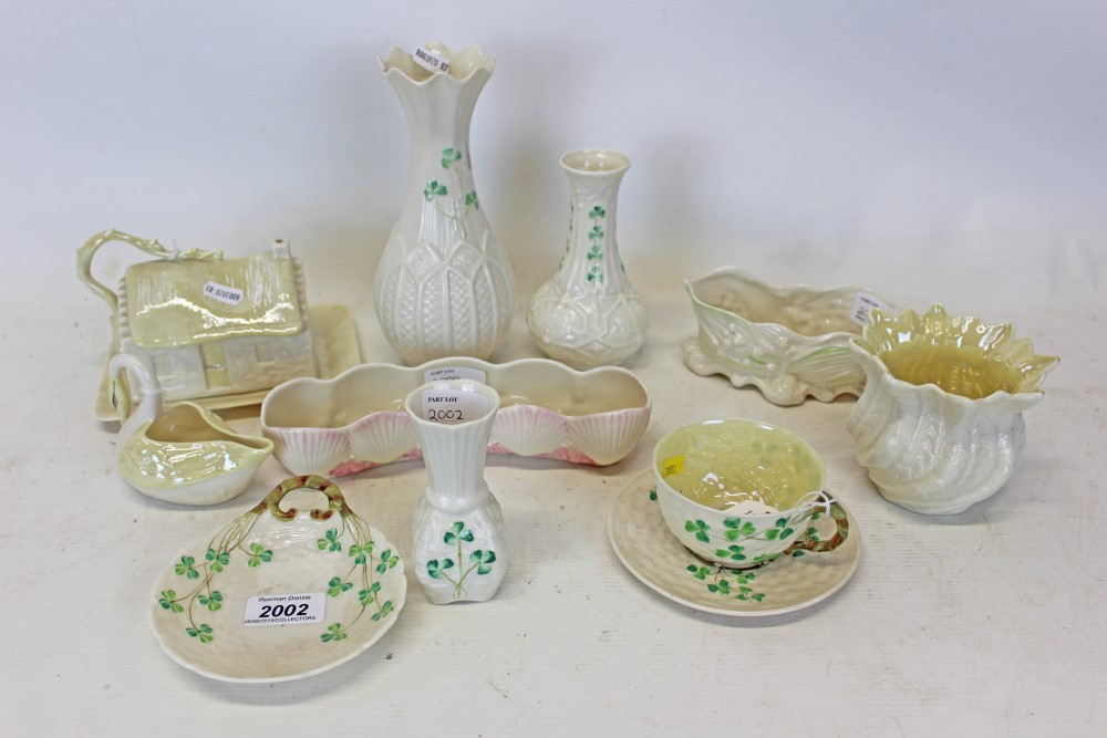 Group of ten pieces of Belleek porcelain to include cup and saucer, swan, butter dish cottage and