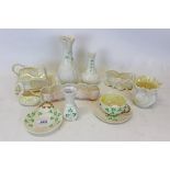 Group of ten pieces of Belleek porcelain to include cup and saucer, swan, butter dish cottage and