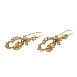 Pair of Edwardian seed pearl pendant earrings of openwork design, in gold setting. 30mm.