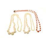 Two ivory necklaces pre 1947, one coral and ivory