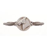 Georg Jensen silver brooch with a circular plaque depicting a horse’s head. Signed and numbered