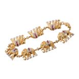 18ct gold bracelet composed of a line of seven elephants, sent with diamonds, rubies and emeralds