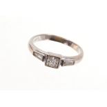 18ct white gold diamond ring with a princess cut diamond flanked by tapered baguette cut diamonds