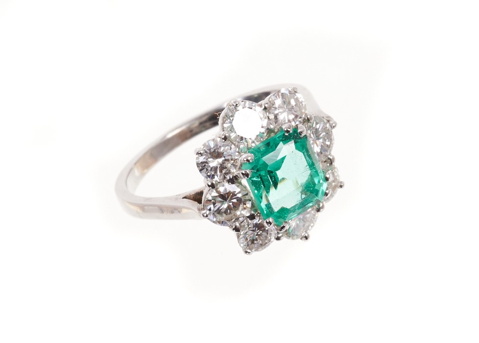 Fine emerald and diamond cluster ring, the rectangular step cut emerald weighing 1.74cts surrounded
