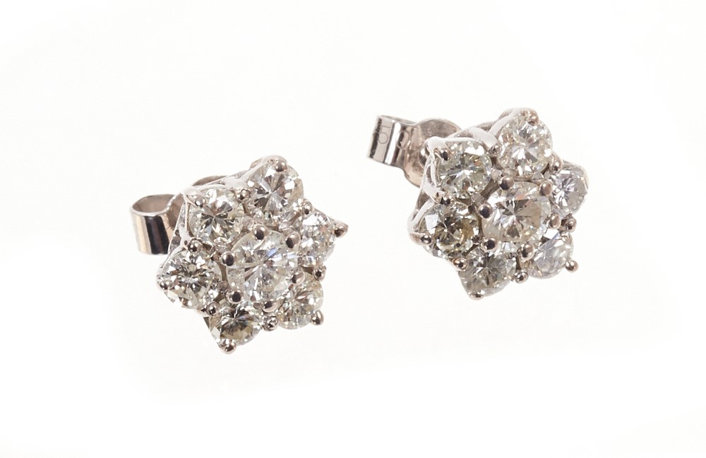 Pair of brilliant cut diamond star shaped cluster stud earrings. Estimated total diamond weight