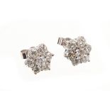 Pair of brilliant cut diamond star shaped cluster stud earrings. Estimated total diamond weight