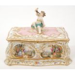 Continental porcelain box and cover with putto surmount