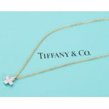 Tiffany diamond and platinum cross pendant on an 18ct yellow gold 18ct chain, in box.