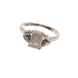Diamond ring with a baguette cut diamond flanked by marquise cut diamonds to the open shoulders, in