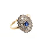 Art Deco style sapphire and diamond cluster ring, the oval bezel with a central mixed cut blue