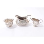 Edwardian silver cream jug and sugar bowl and one other cream jug (3)