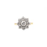 Diamond cluster ring with a flower head cluster of nine brilliant cut diamonds in claw setting on