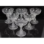 Set of six good quality glass champagne bowls with cut snowflake motifs on cut and faceted stems,