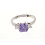 Natural purple sapphire and diamond three stone ring with an octagonal cut natural purple Ceylon