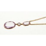 Pink topaz and diamond pendant necklace with two oval mixed cut pink topaz and an old cut diamond,