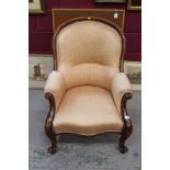 Victorian spoon back easy chair with carved mahogany frame on cabriole legs, with patterned