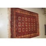 Large Afghan Carpet with geometric decoration on red ground
