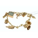 9ct gold charm bracelet with nine gold charms