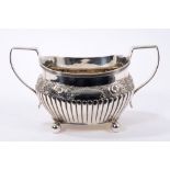 George III silver two-handled sugar bowl of half-fluted form, with floral decoration.