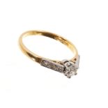 Diamond single stone ring with a brilliant cut diamond in claw setting and diamond set shoulders