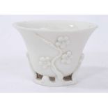 17th century Chinese blanc de chine libation cup with prunus decoration