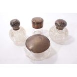 Collection of four Victorian and later cut glass toilet jars with silver mounts