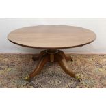 Substantial mahogany circular dining table, the expansive circular top on massive bulbous column