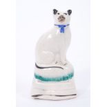 Mid 19th century Staffordshire model of a cat, sparsely decorated in enamels
