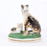 Mid 19th century Staffordshire porcelaneous model of a tortoiseshell-coloured cat and kitten