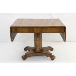 Regency rosewood sofa table, having rounded rectangular drop-leaf top and two frieze drawers with