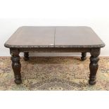 Large late 19th century carved oak extending dining table