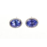Pair of tanzanite and diamond cluster earrings, each with an oval mixed cut tanzanite surrounded by