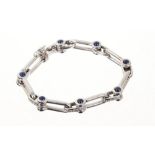 18ct white gold bracelet with stirrup links, cabochon sapphire terminals and diamond set spacers.