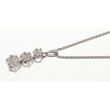 Diamond pendant with a triple flowerhead cluster of brilliant cut diamonds estimated to weigh