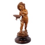 Well carved pine figure of a putto with shell in hand on wooden base