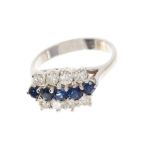 Sapphire and diamond cluster ring with a triple row of blue sapphires and brilliant cut diamonds in