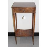 Regency burr yew wood two tier side table, with frieze drawer and shelf below on slender tapered