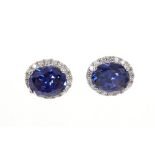 Pair of Tanzanite and diamond cluster earrings, each with a large oval mixed cut Tanzanite ,