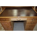 Early 20th century limed oak and pine desk, with leatherette inset top over six drawers sand one