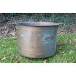 Large copper vessel, of riveted form with everted rim, flanking handles, 62cm diameter