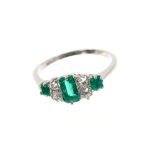 Emerald and diamond ring with three step cut emeralds weighing approximately 0.60cts and four old