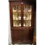 George III mahogany two height corner cupboard with astragal glazed doors above and two panelled