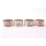 Four silver napkin rings of oval form with engraved game bird and fish decoration