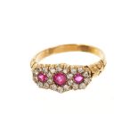 Edwardian-style ruby and diamond triple cluster ring with three flower head clusters, each with a