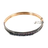 Late Victorian diamond, ruby and sapphire hinged bangle