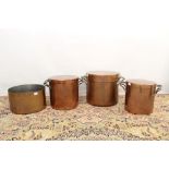 Three large graduated copper vessels and covers, each of plain cylindrical lidded form with two
