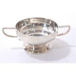 Edwardian silver two handled sugar bowl with angular handles and circular pedestal foot.